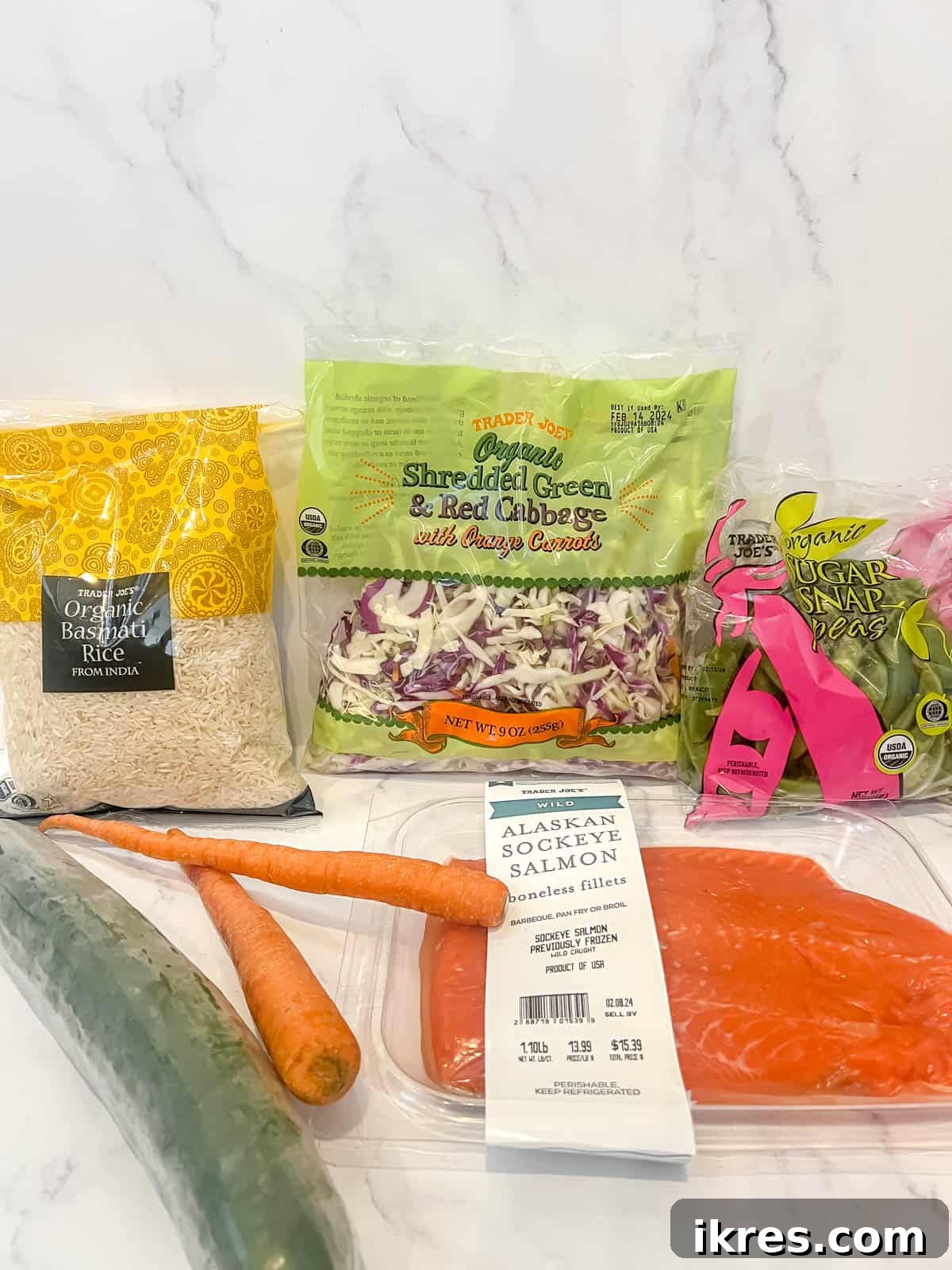A visual display of all fresh ingredients required for the salmon rice bowl, including salmon fillets, rice, various vegetables, and condiments.
