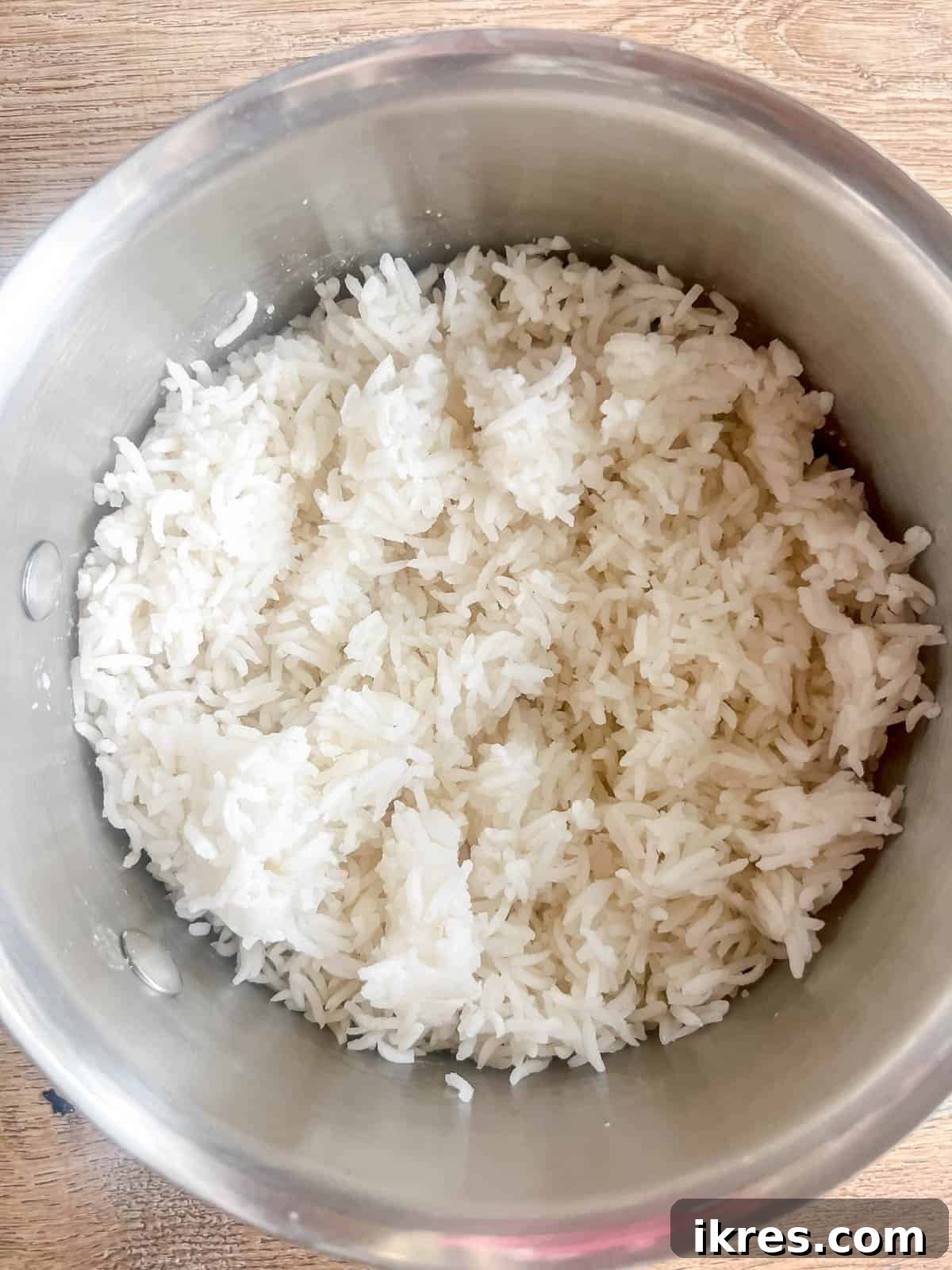 White rice cooking in a pot on the stove.