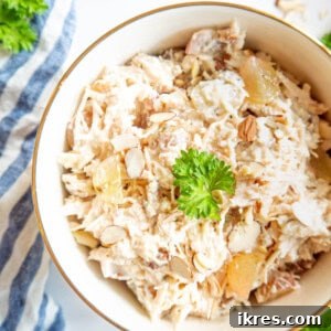 High Protein Canned Chicken Salad with Greek Yogurt in a bowl with almonds and grapes on top.