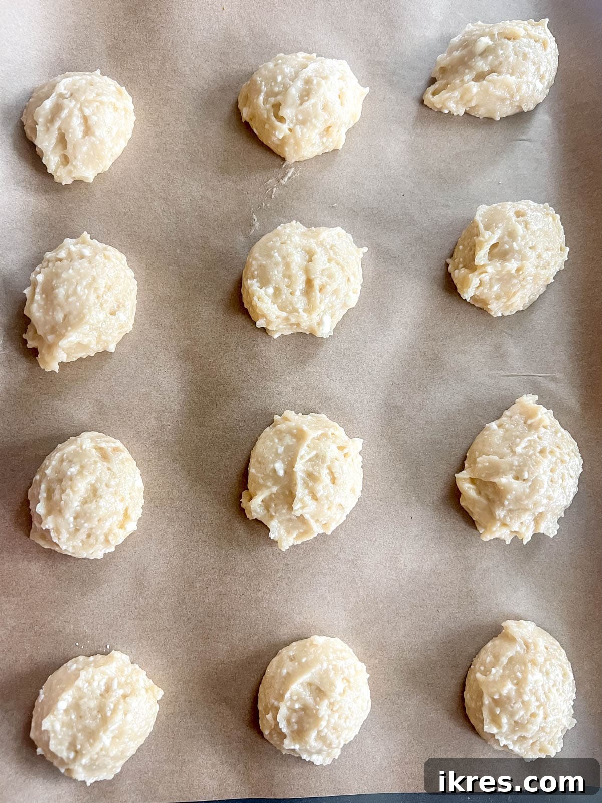 Pillowy Cottage Cookies 11 Scooped cottage cheese sugar cookie dough balls placed on a baking sheet before baking.