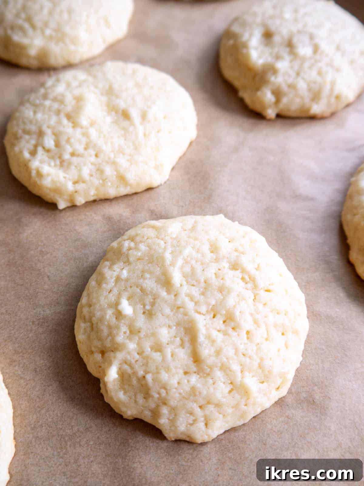 Pillowy Cottage Cookies 14 A single cottage cheese sugar cookie resting on a baking pan, ready to be enjoyed.