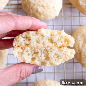 A cottage cheese cookie cut in half, showcasing its soft interior and golden edges.