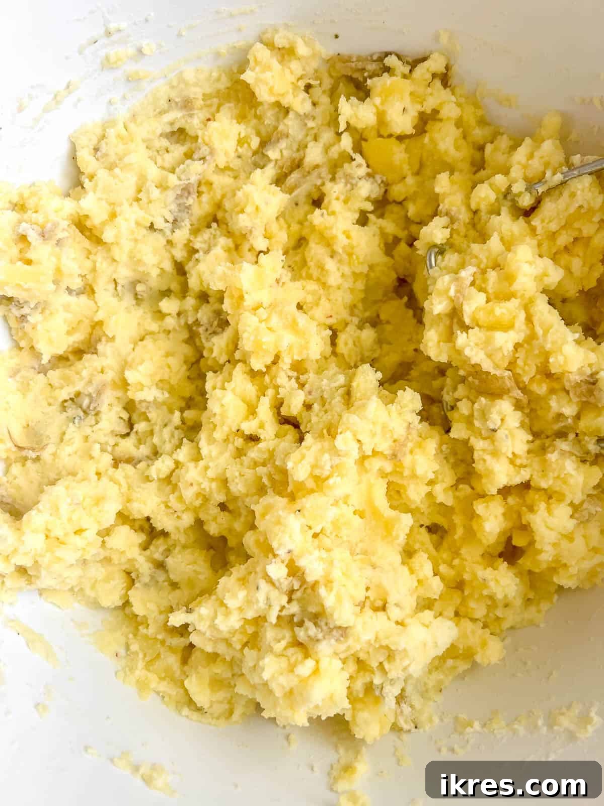 Finished Greek yogurt mashed potatoes in a bowl, ready to be served, showing a rich and smooth texture.