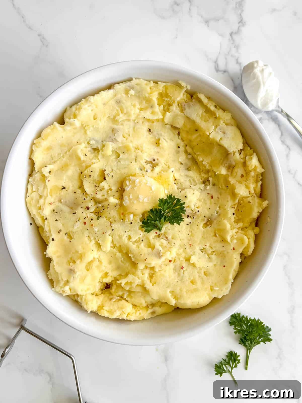 A large bowl of creamy Greek yogurt mashed potatoes, perfectly smooth and inviting.