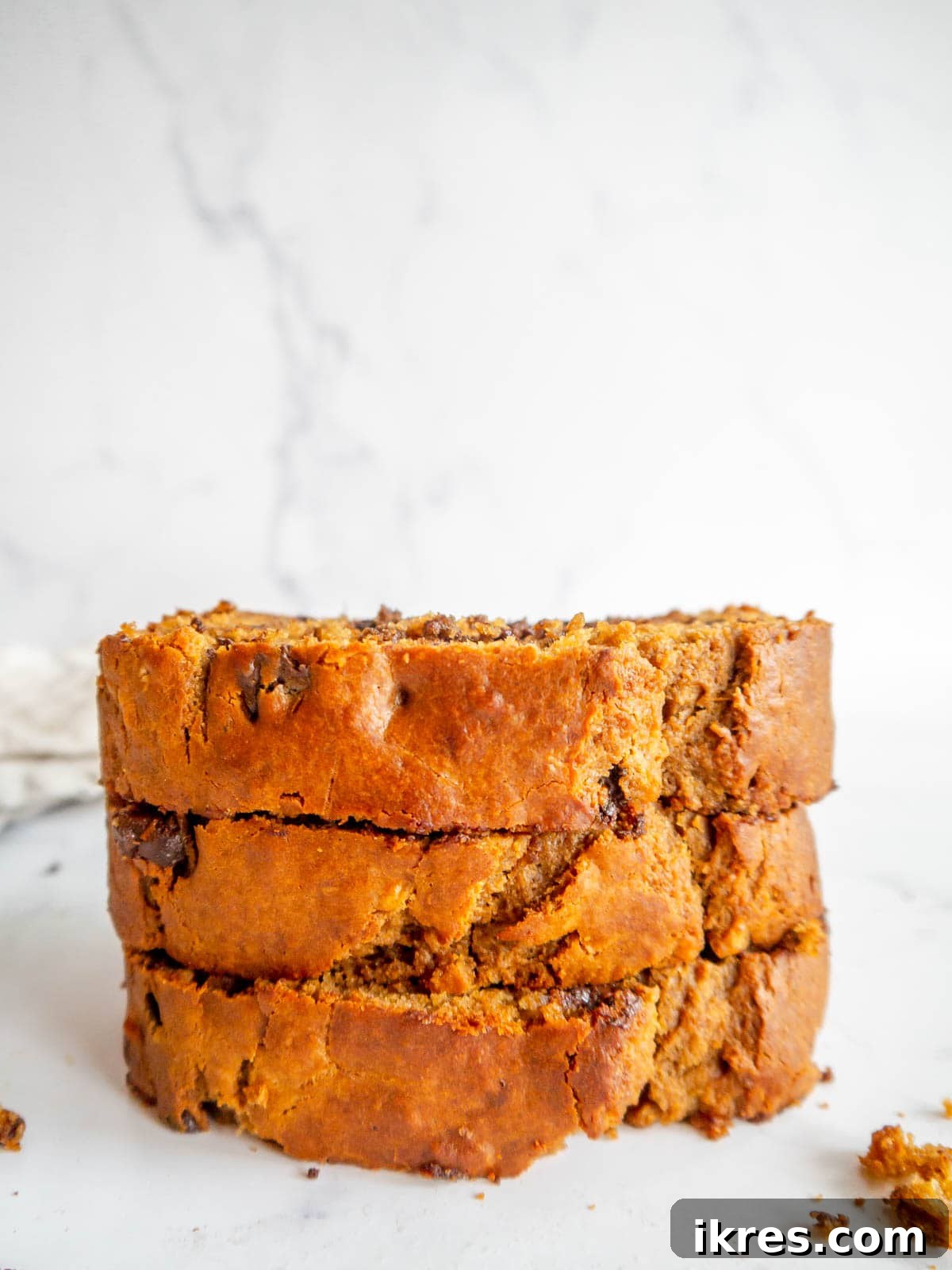 Slices of banana bread made with greek yogurt stacked on top of each other.