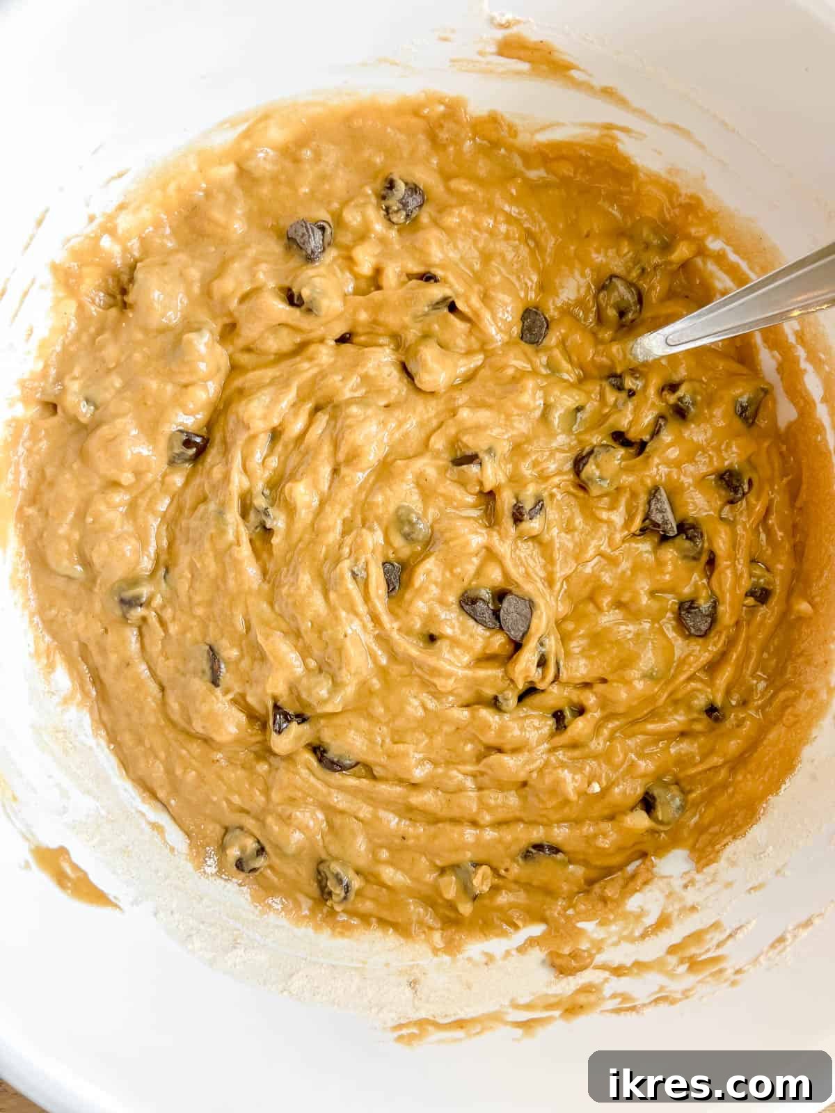 Batter for banana bread using greek yogurt and chocolate chips.
