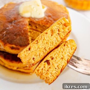 A close-up of a stack of healthy pumpkin pancakes on a plate, ready to be served.