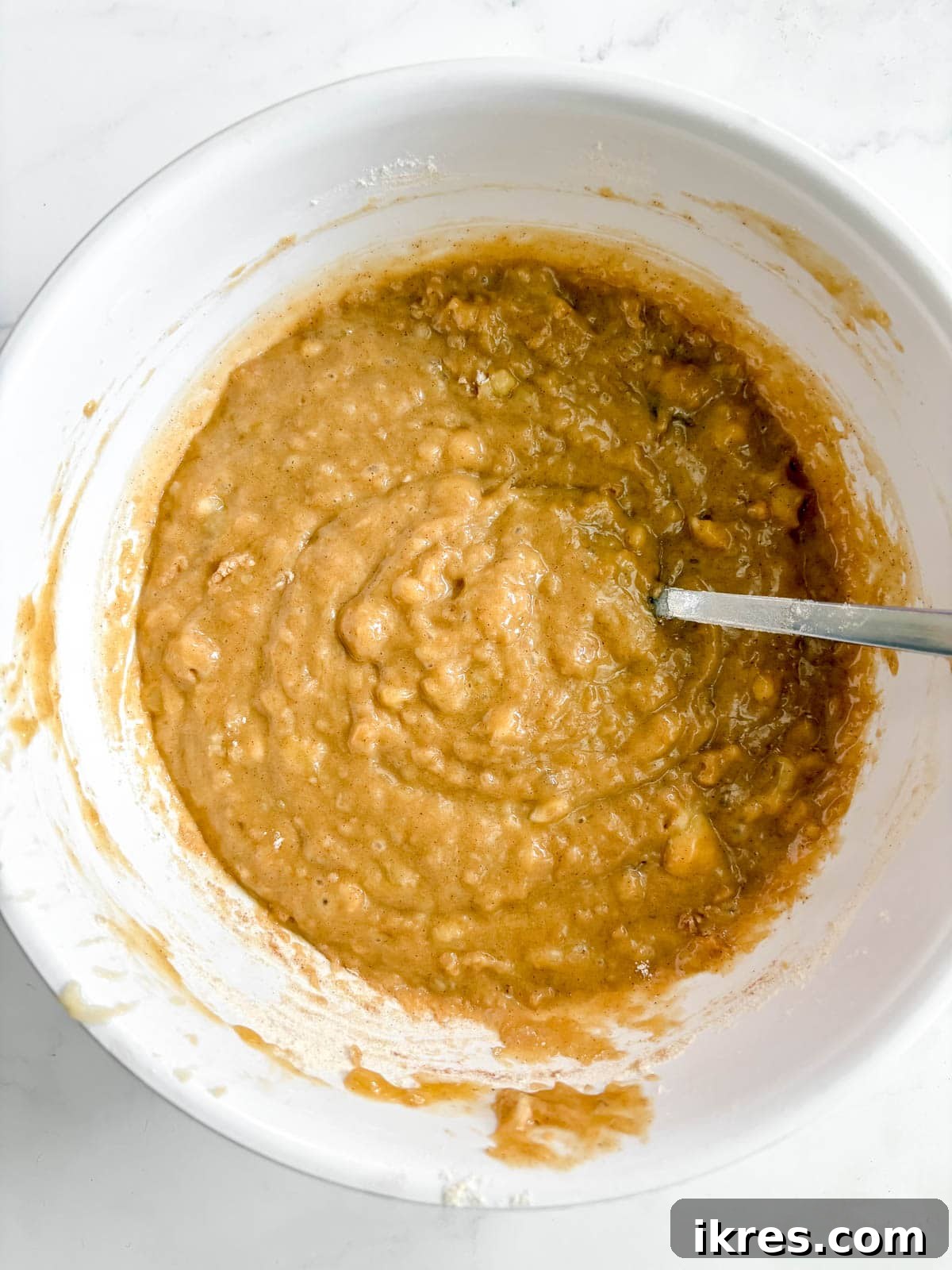 Golden Olive Oil Banana Bread 6 Olive oil banana bread batter in a mixing bowl, showing the consistency before pouring.