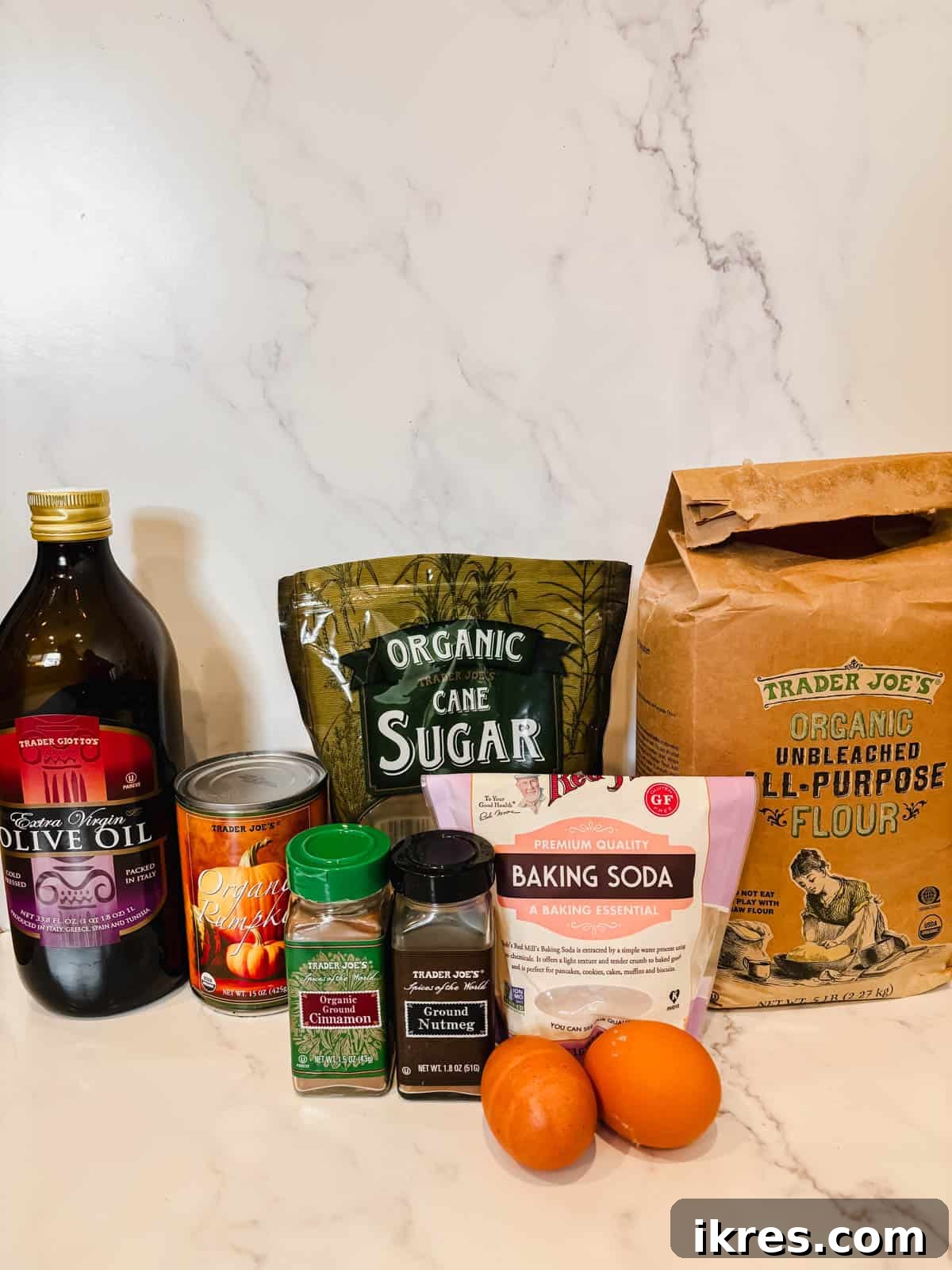 Autumn Spiced Dairy-Free Pumpkin Bread 3 A collection of ingredients laid out for making dairy-free pumpkin bread, including flour, sugar, spices, pumpkin puree, and olive oil.