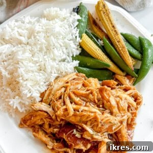 Plate of honey garlic chicken with rice, snap peas, and corn.