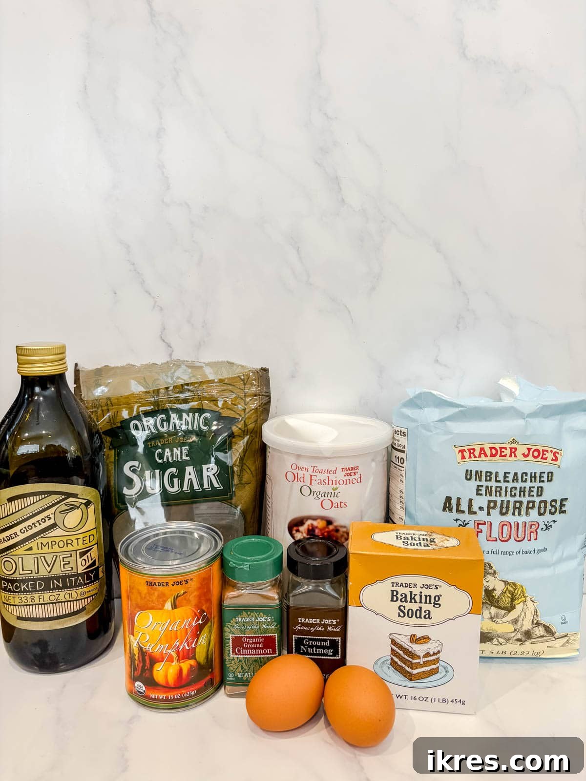 Plant-Based Pumpkin Spice Oat Muffins 3 A flat lay photograph showcasing all the dry and wet ingredients neatly arranged for making pumpkin oat muffins.
