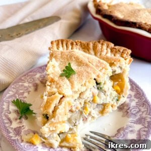 A slice of chicken pot pie made with store bought crust on a plate.