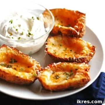 Four potato skins on a white plate.
