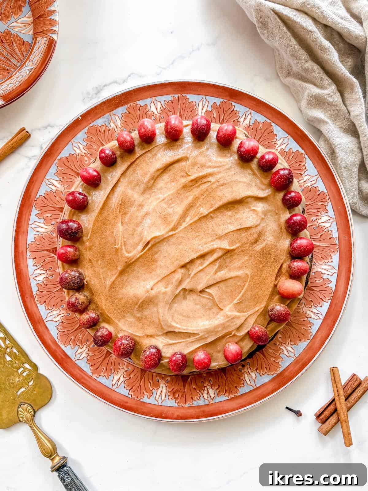 Spiced Gingerbread Cake with Tangy Cinnamon Cream Cheese Frosting 12 Fully frosted Gingerbread Cake with cinnamon cream cheese frosting, decorated with fresh red cranberries.