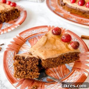 Spiced Gingerbread Cake with Tangy Cinnamon Cream Cheese Frosting 15 A close-up slice of Gingerbread Cake with Cinnamon Cream Cheese Frosting, showing the moist crumb and creamy topping.