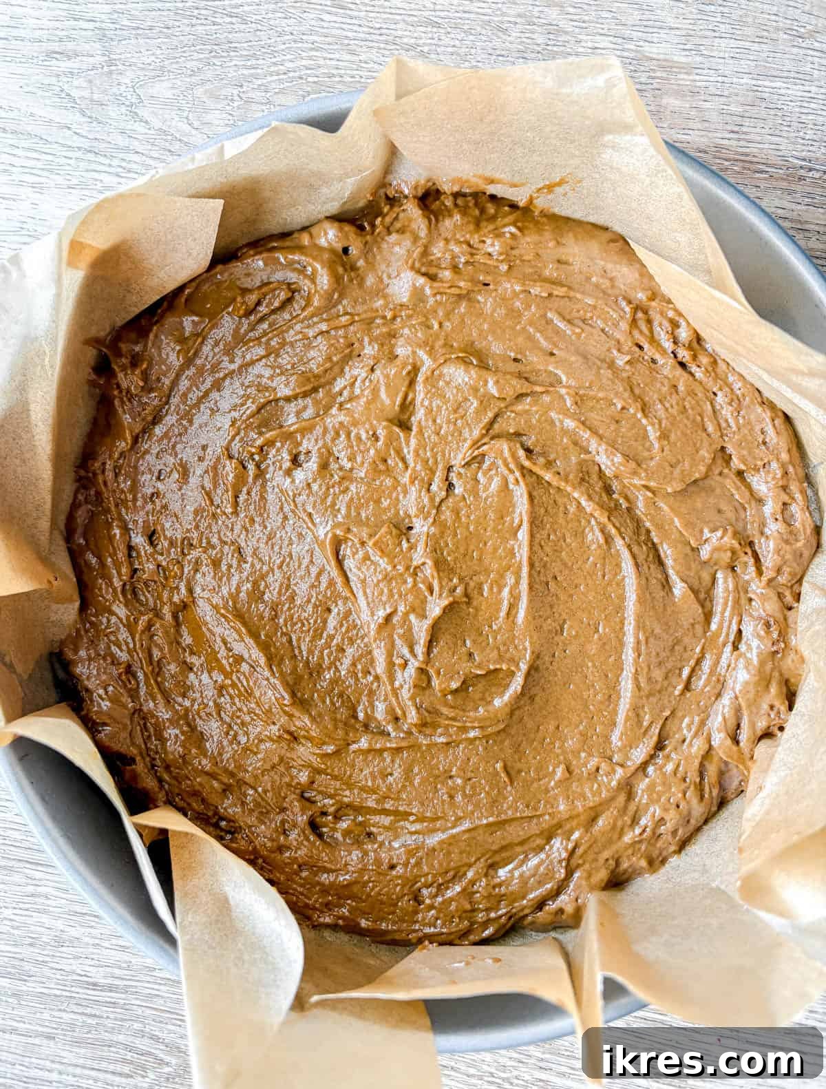 Spiced Gingerbread Cake with Tangy Cinnamon Cream Cheese Frosting 9 Gingerbread Cake batter poured into a round baking pan, ready for the oven.