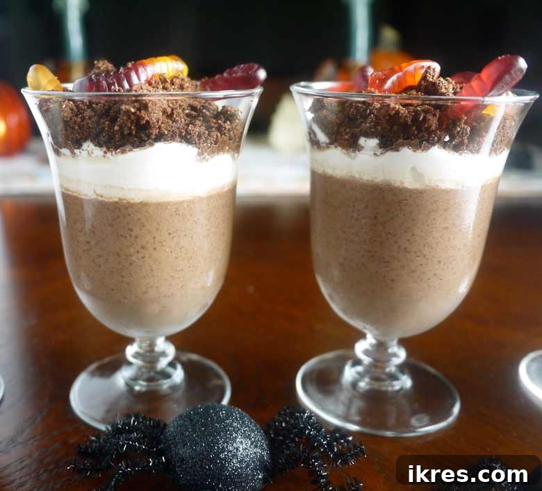 Paleo GF Clean Dirt Delight 3 Clean "Dirt" with a spoon, showing layers of chia pudding and cookie crumble
