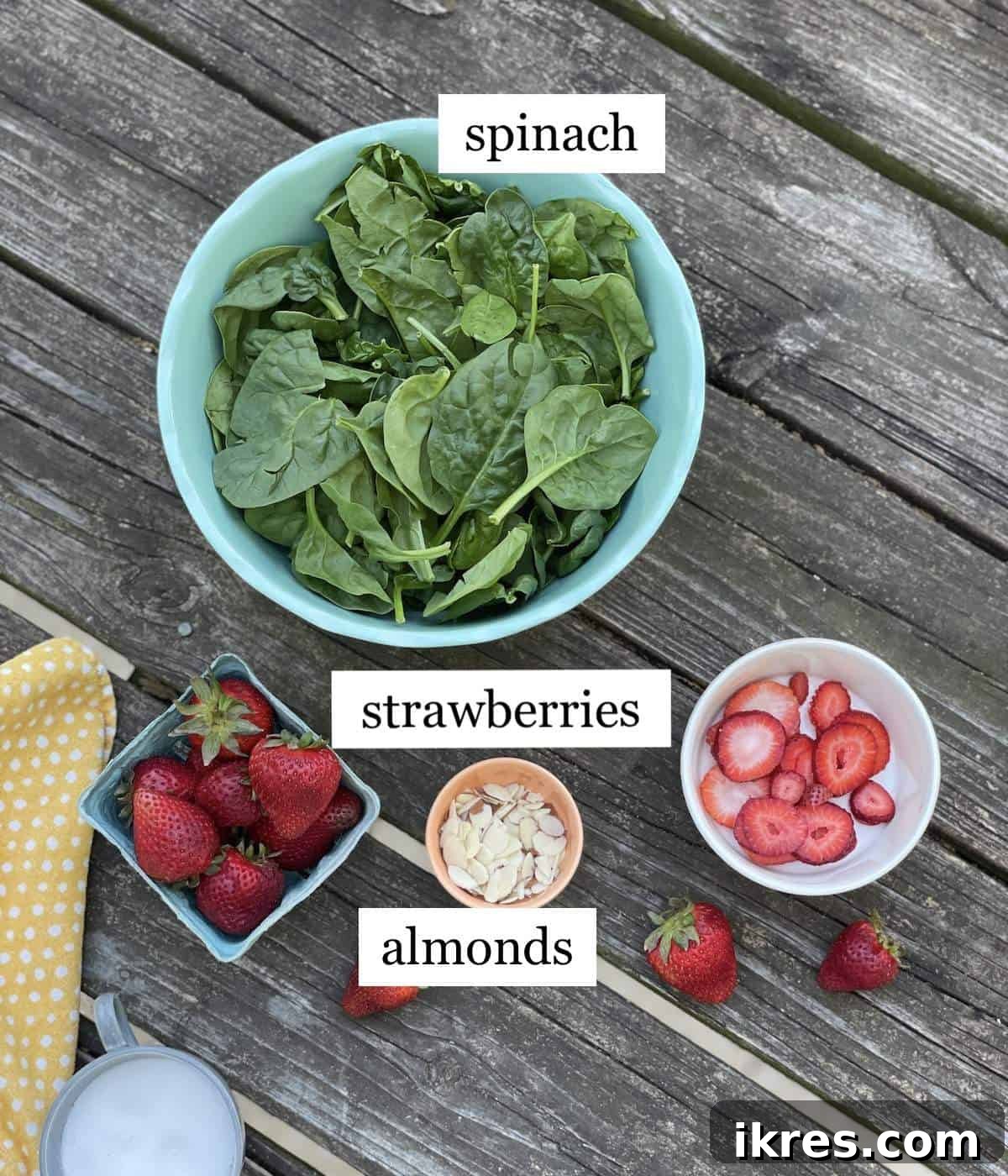 Close-up view of fresh spinach and sliced strawberries, ready to be combined for the perfect summer salad.
