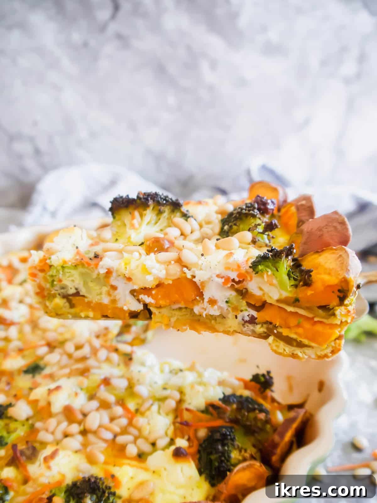 Vibrant Broccoli Carrot and Goat Cheese Quiche on a Gluten-Free Sweet Potato Crust 4 A close-up of a slice of quiche, showing the sweet potato crust and the rich, colorful vegetable filling.