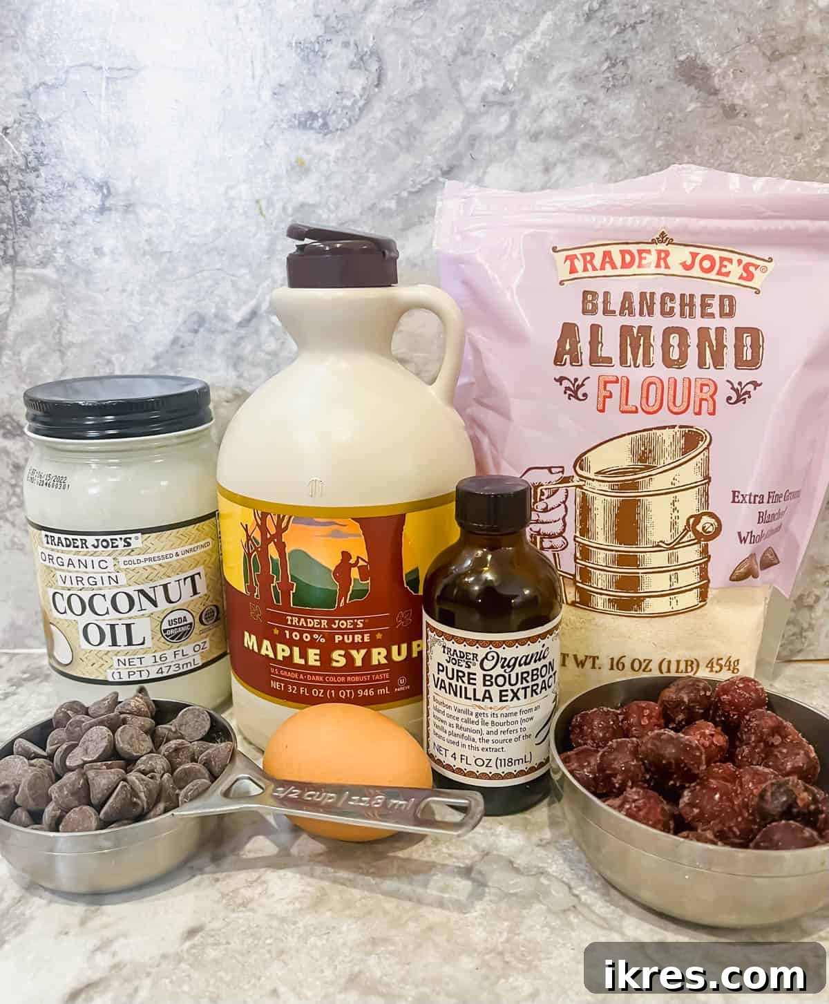 Ingredients needed to make paleo chocolate cherry lava cakes, laid out on a surface.