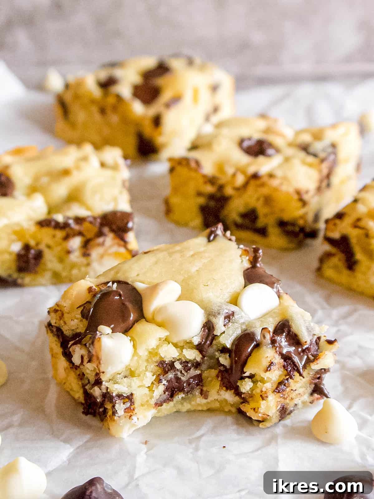 Decadent White Chocolate Brownies with a bite taken out, showing their fudgy interior.