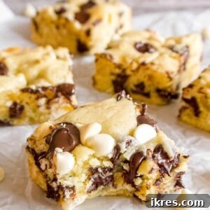 White chocolate brownies with a bite taken out of it, showcasing its delicious texture.