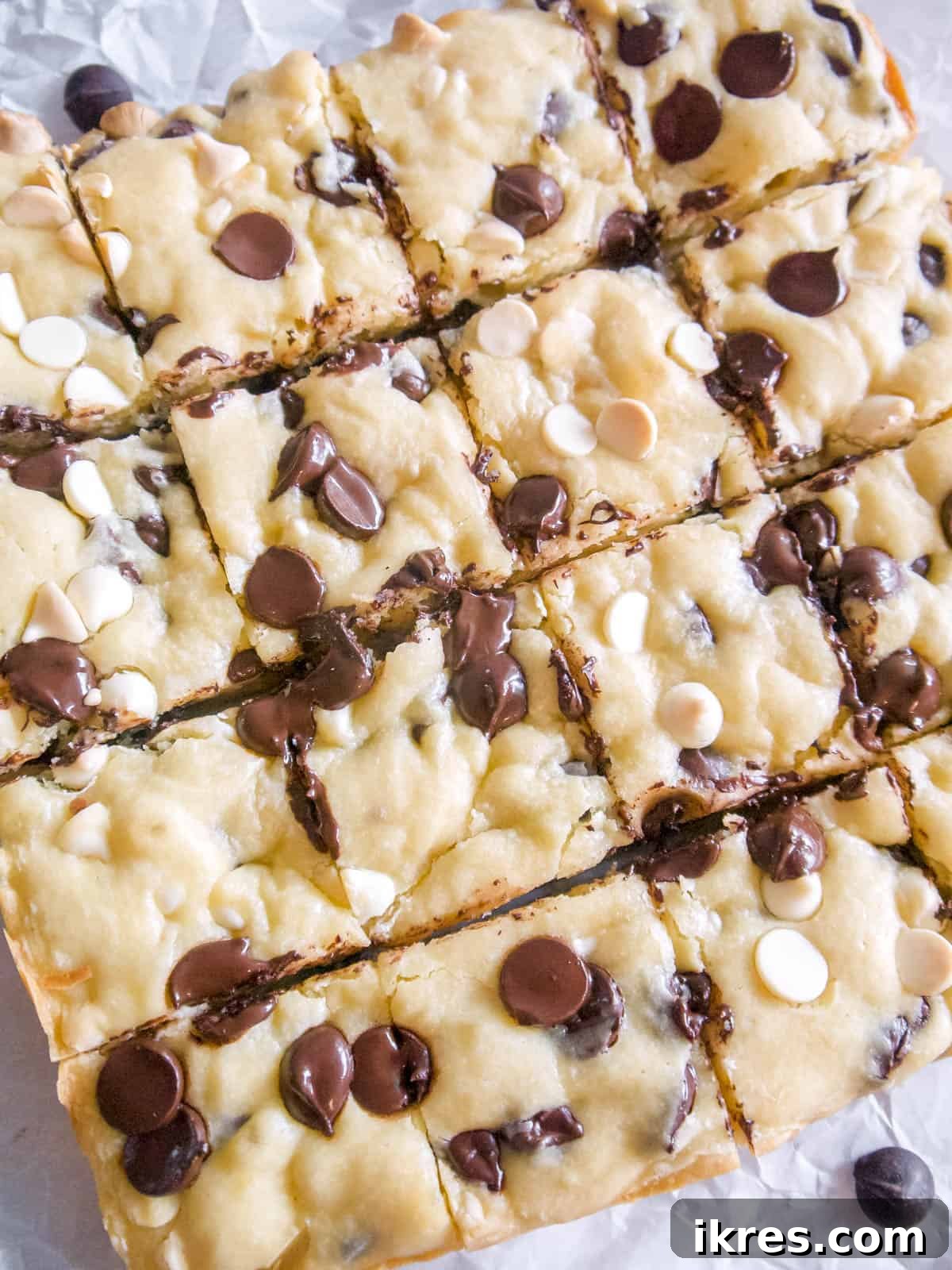 Freshly baked and sliced White Chocolate Brownies with melted chocolate chips visible.