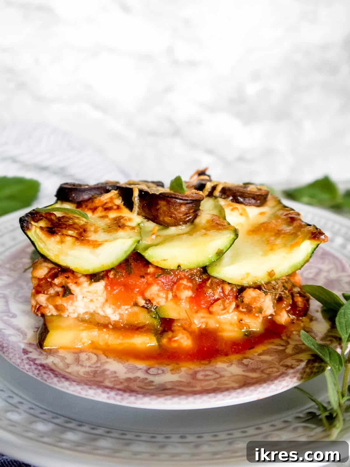 Zucchini Lasagna Reimagined: Gluten-Free, Meaty, and Mushroom Packed 3 A mouth-watering side angle view of a golden-brown zucchini mushroom lasagna on a plate, ready to be enjoyed.