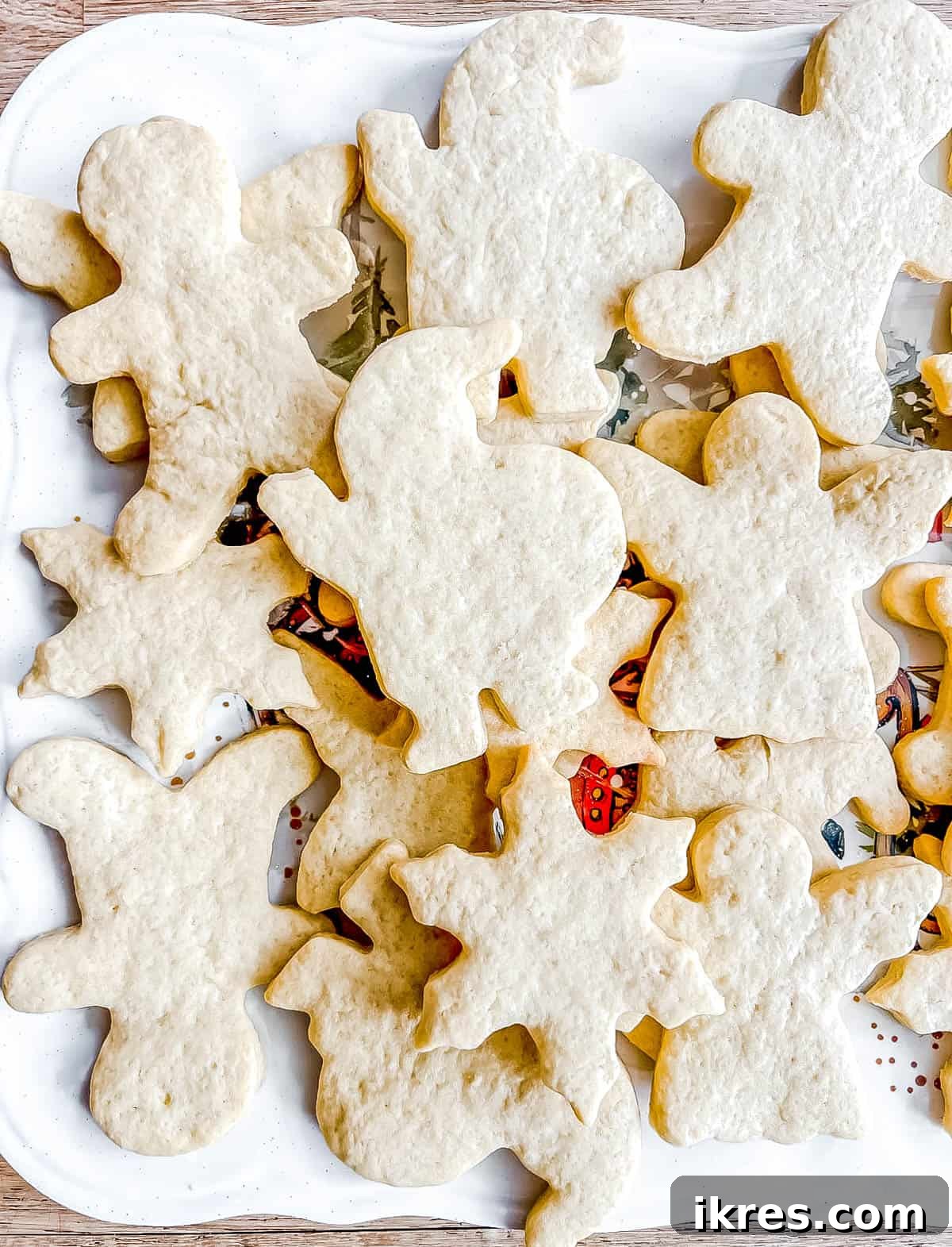 Freshly baked Sable Cut Out Sugar Cookies arranged on a serving plate, ready to be decorated.