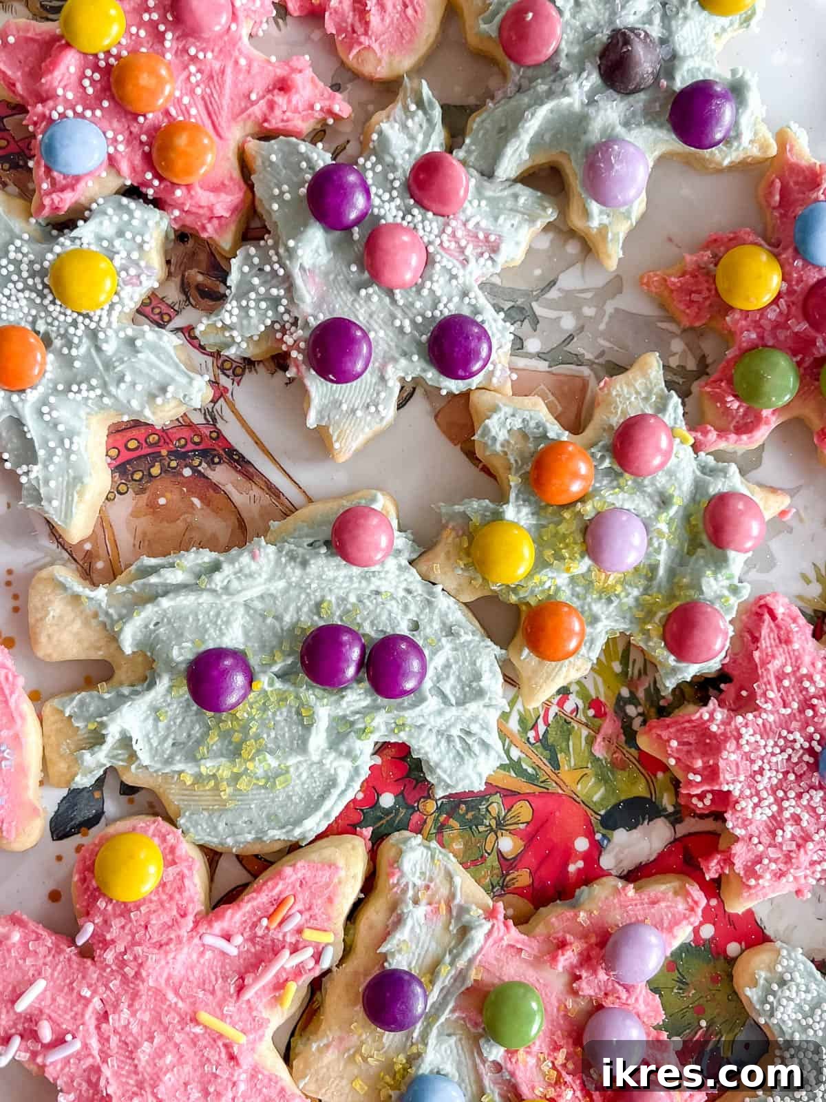 Assorted sable cut out sugar cookies frosted and decorated with colorful icing and sprinkles.