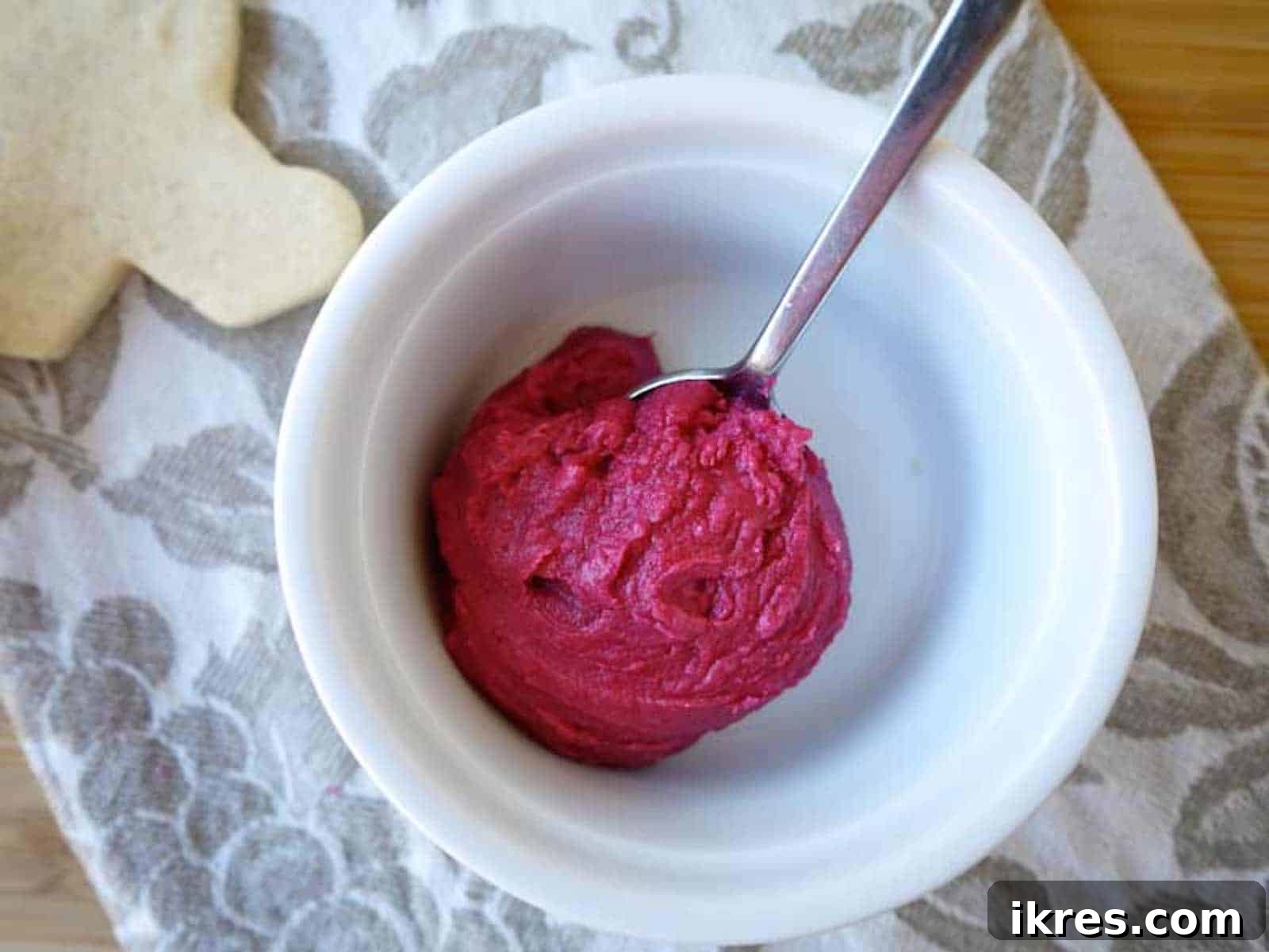 Vibrant pink beet coconut oil frosting in a bowl, a natural coloring option for cookies.