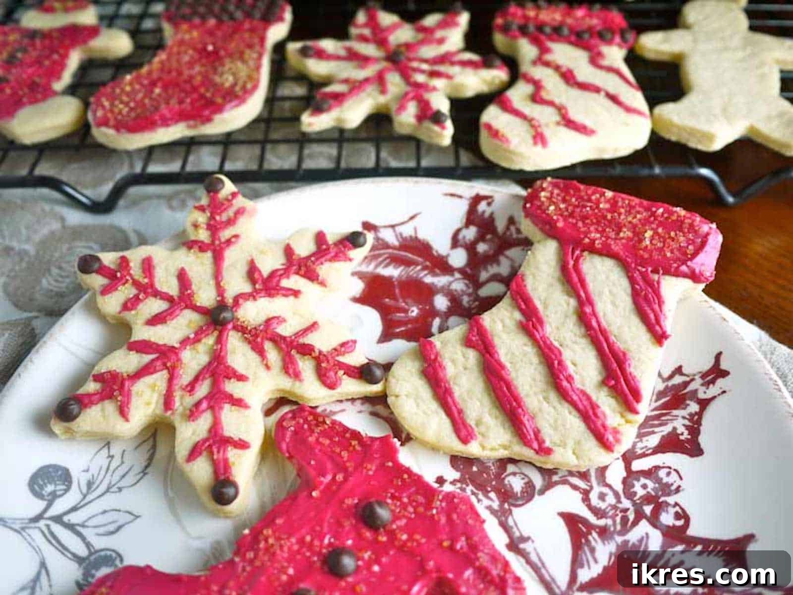 Decorated sable cookies with natural beet coconut oil frosting, showcasing various designs.