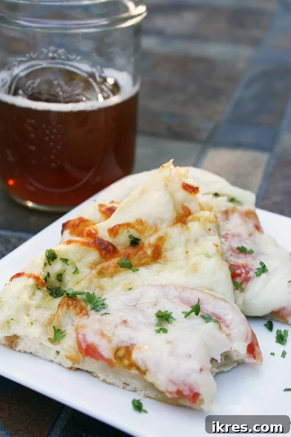 Classic white pizza with melted cheese, fresh tomatoes, and basil.