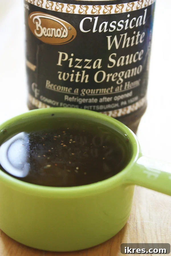 Bottle of Beano's Classical White Pizza Sauce with Oregano, a key ingredient for the white pizza.