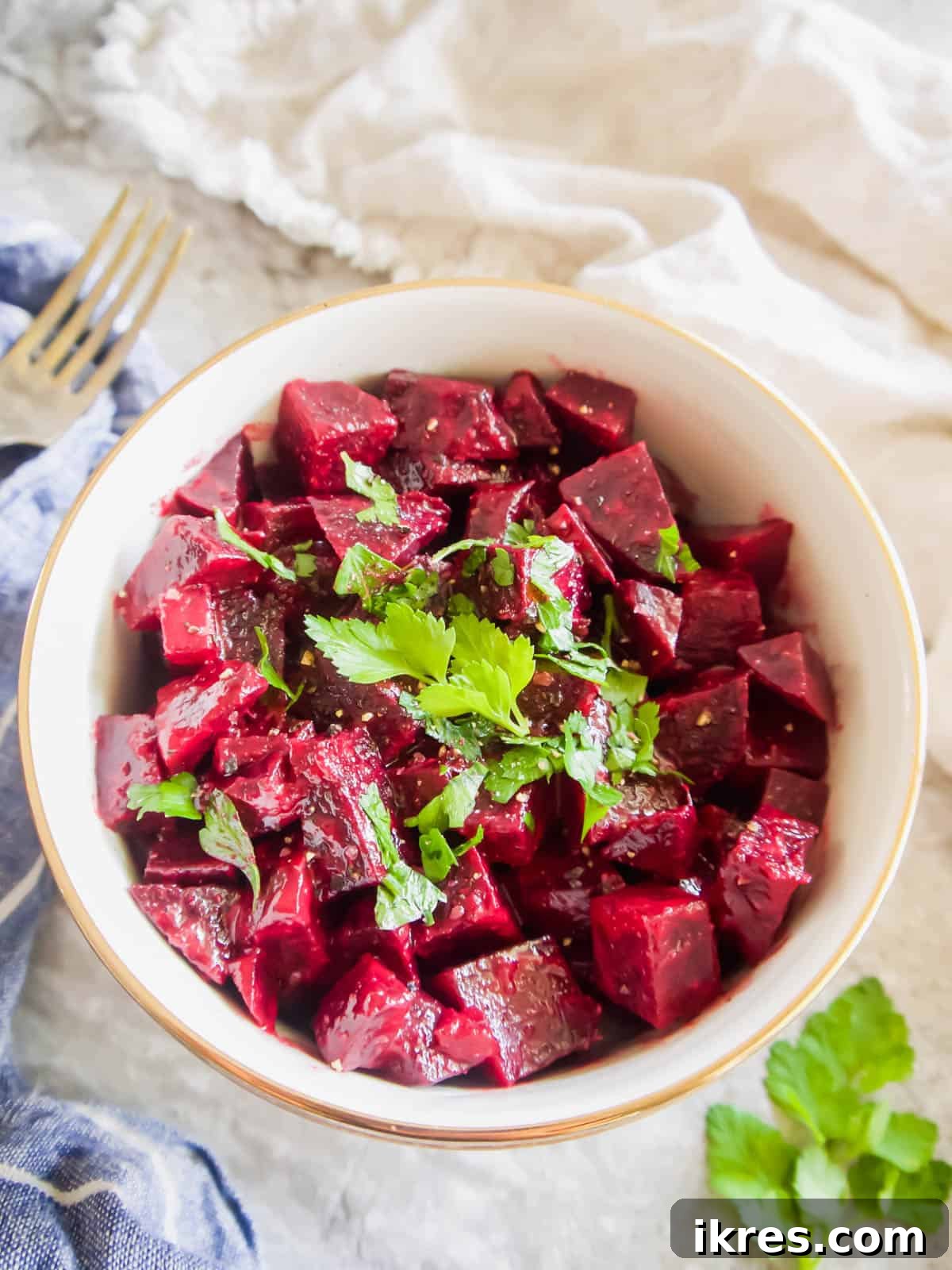 Provencal Beet Salad with Tangy Mustard Vinaigrette 3 Close-up of a Boiled Beet Salad served in a rustic bowl, with a fork poised on the side, highlighting its appealing texture and color.