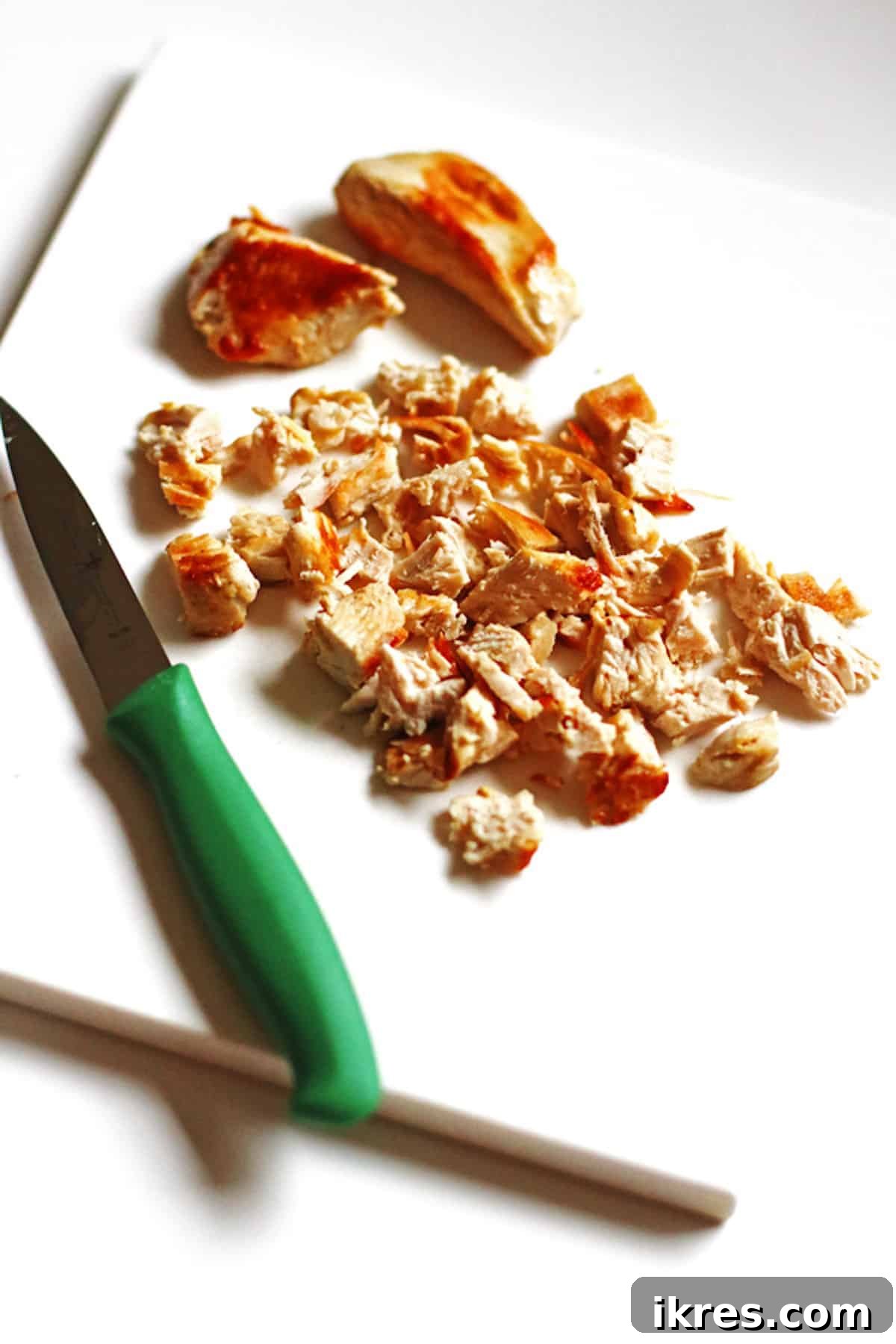Diced chicken on a plate to make buffalo chicken dip.