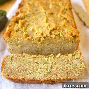 A delicious slice of Buttery Zucchini Banana Bread, paleo and gluten-free, ready to eat