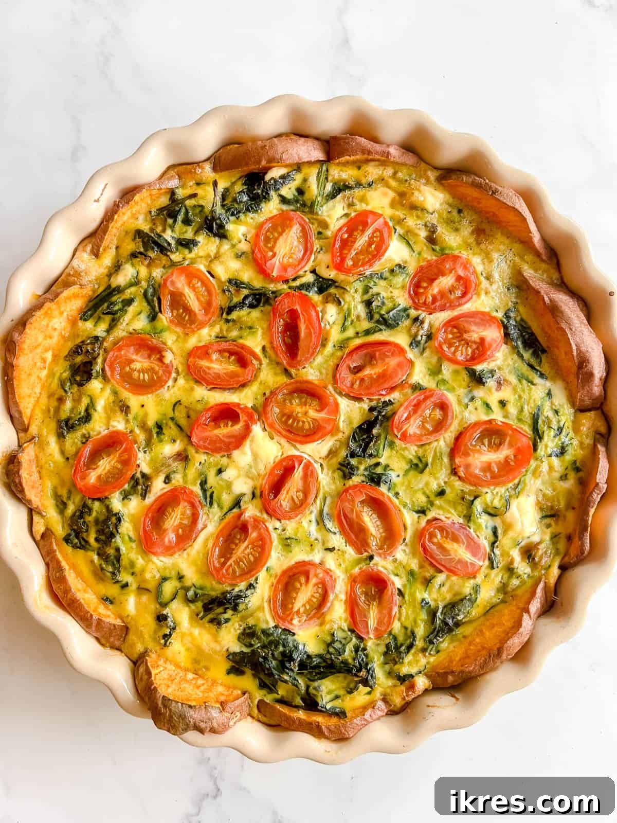 The finished Zucchini and Kale Quiche with a sweet potato crust after baking, golden brown and perfectly set.