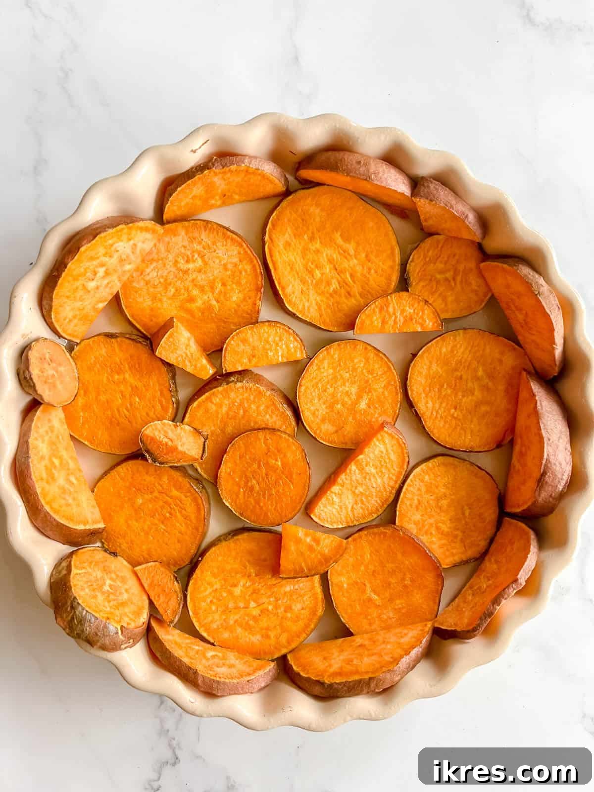 The sweet potato crust after being pre-baked, showing a slightly softened texture and beginning to turn golden brown.