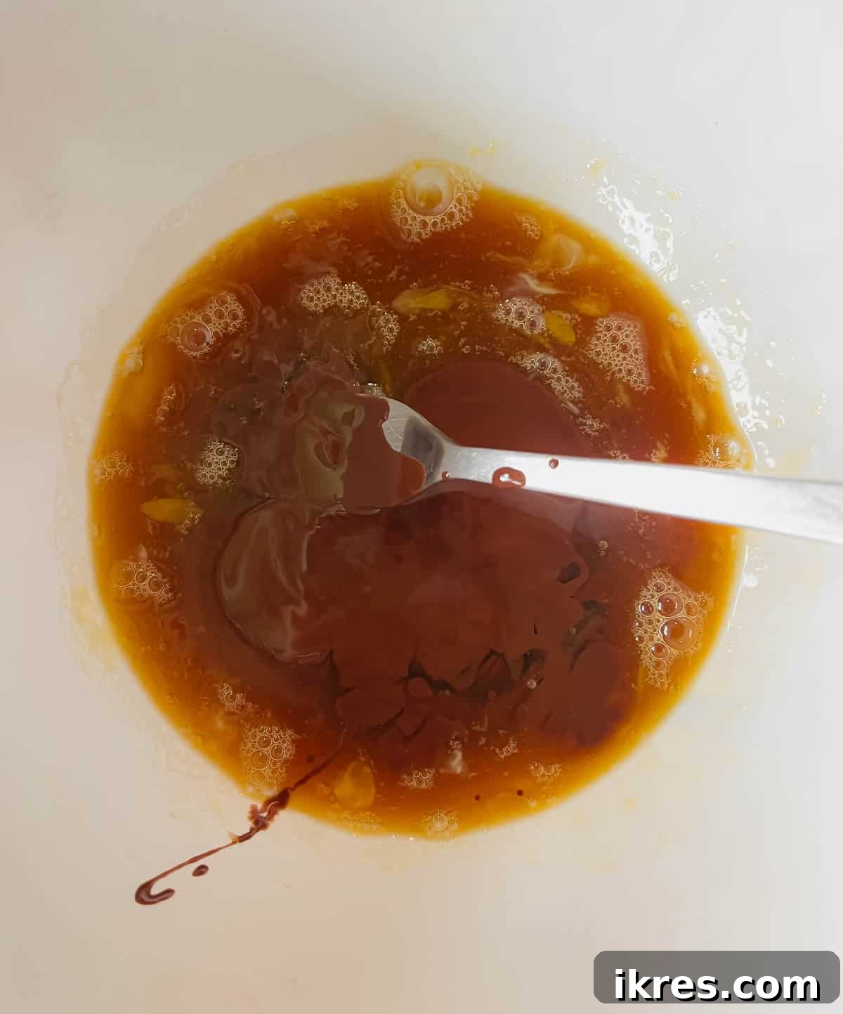Decadent Gluten Dairy Free Molten Lava Cakes 7 Melted chocolate mixture being added to the egg and maple syrup mixture.