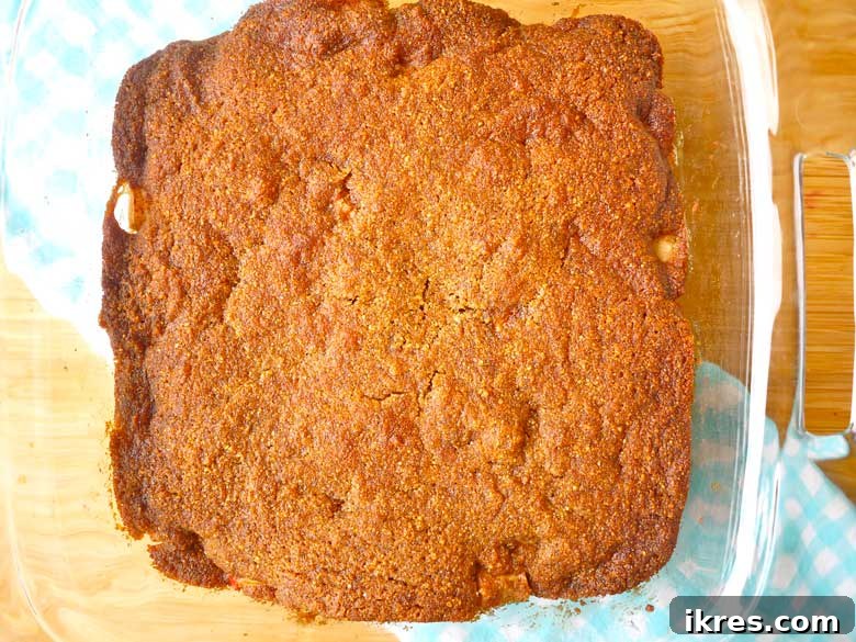 Grain-Free Apple Cobbler Delight 4 Serving of Paleo Ginger Cookie Apple Cobbler with a spoonful removed