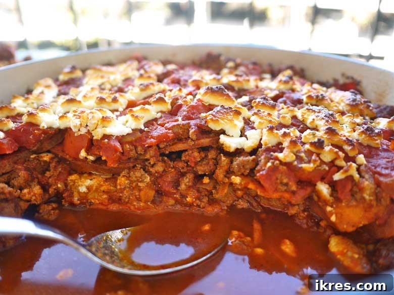 A close-up of a serving of Sweet Potato and Ground Turkey Enchilada Casserole, showcasing its delicious layers and texture, a paleo and gluten-free recipe from Perchance to Cook.