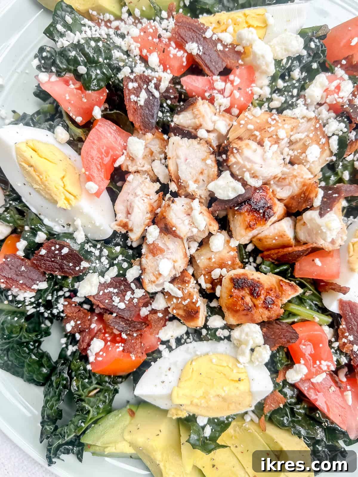 Power-Packed Kale Cobb Salad 11 An up-close, vibrant photograph of the healthy kale cobb salad, highlighting the fresh textures and colorful ingredients in detail. Keywords: healthy cobb salad, kale salad close-up.