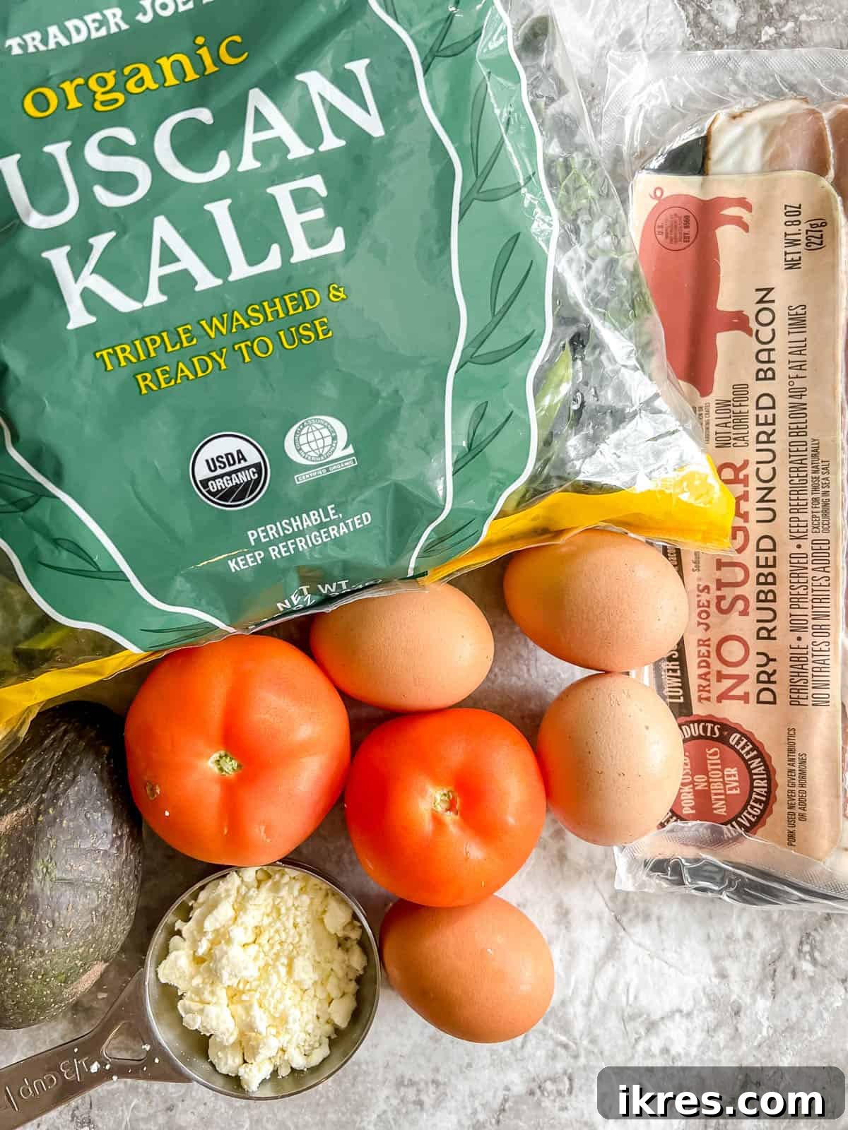 Power-Packed Kale Cobb Salad 3 A selection of fresh produce including vibrant kale, eggs, avocado, and tomatoes, which are the main ingredients for a healthy cobb salad.