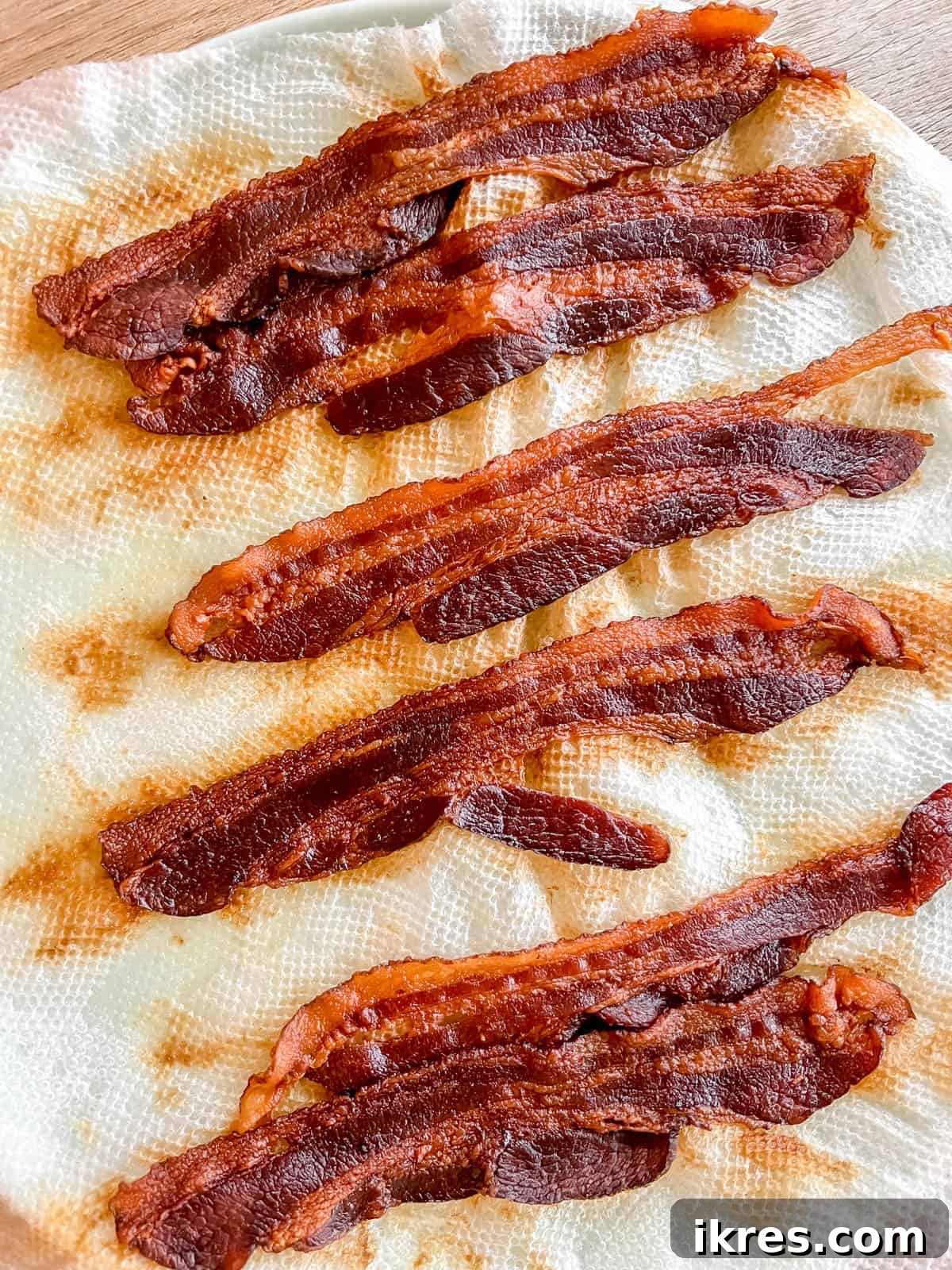 Power-Packed Kale Cobb Salad 7 Crispy bacon strips, freshly cooked and placed on paper towels to drain excess fat, ready to be crumbled for the salad.