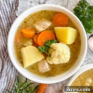 Paleo chicken soup in a bowl on a table.