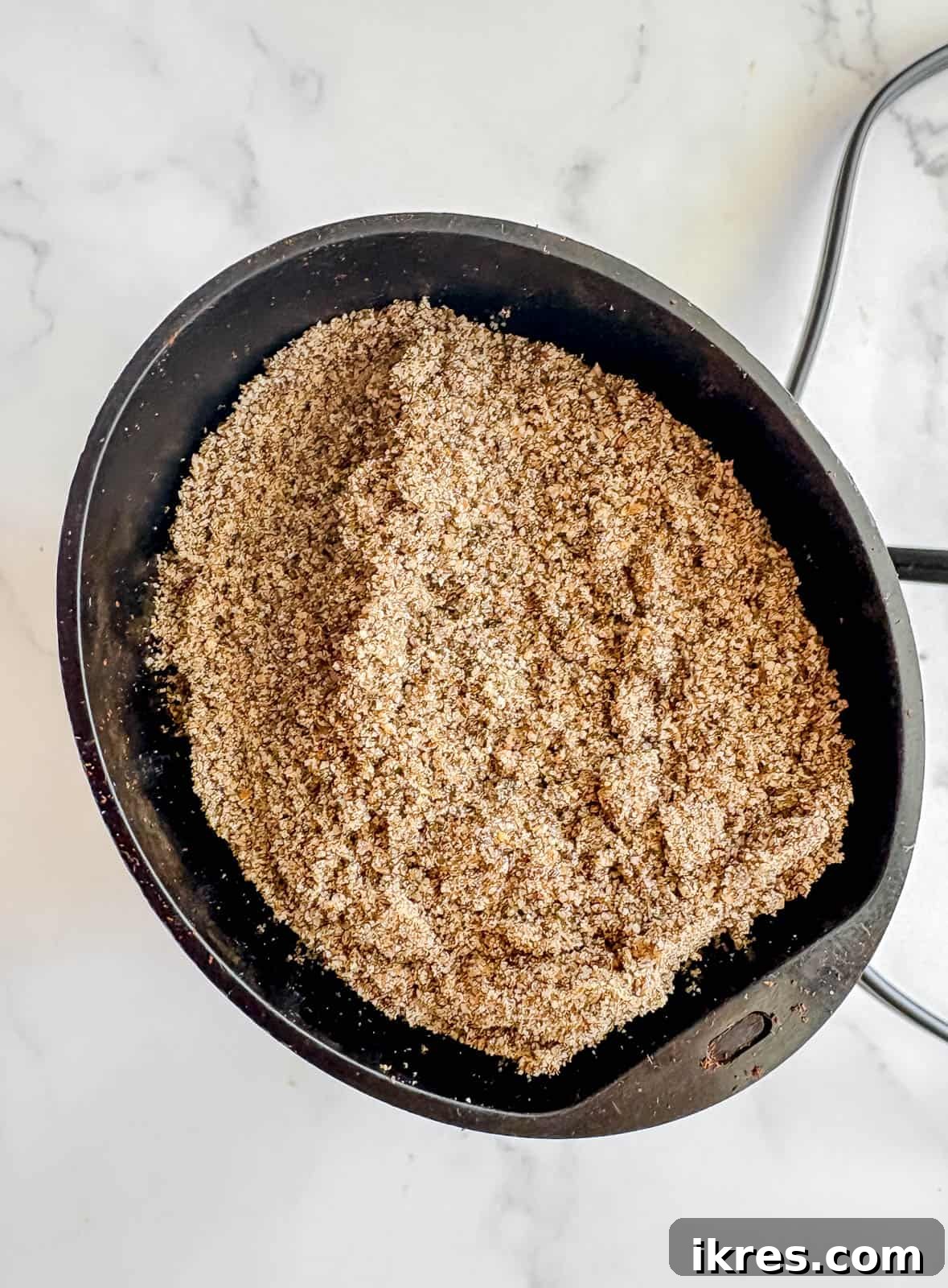 A coffee grinder being used to finely grind chia seeds, showcasing the first step in preparing the ingredients for the pancakes.