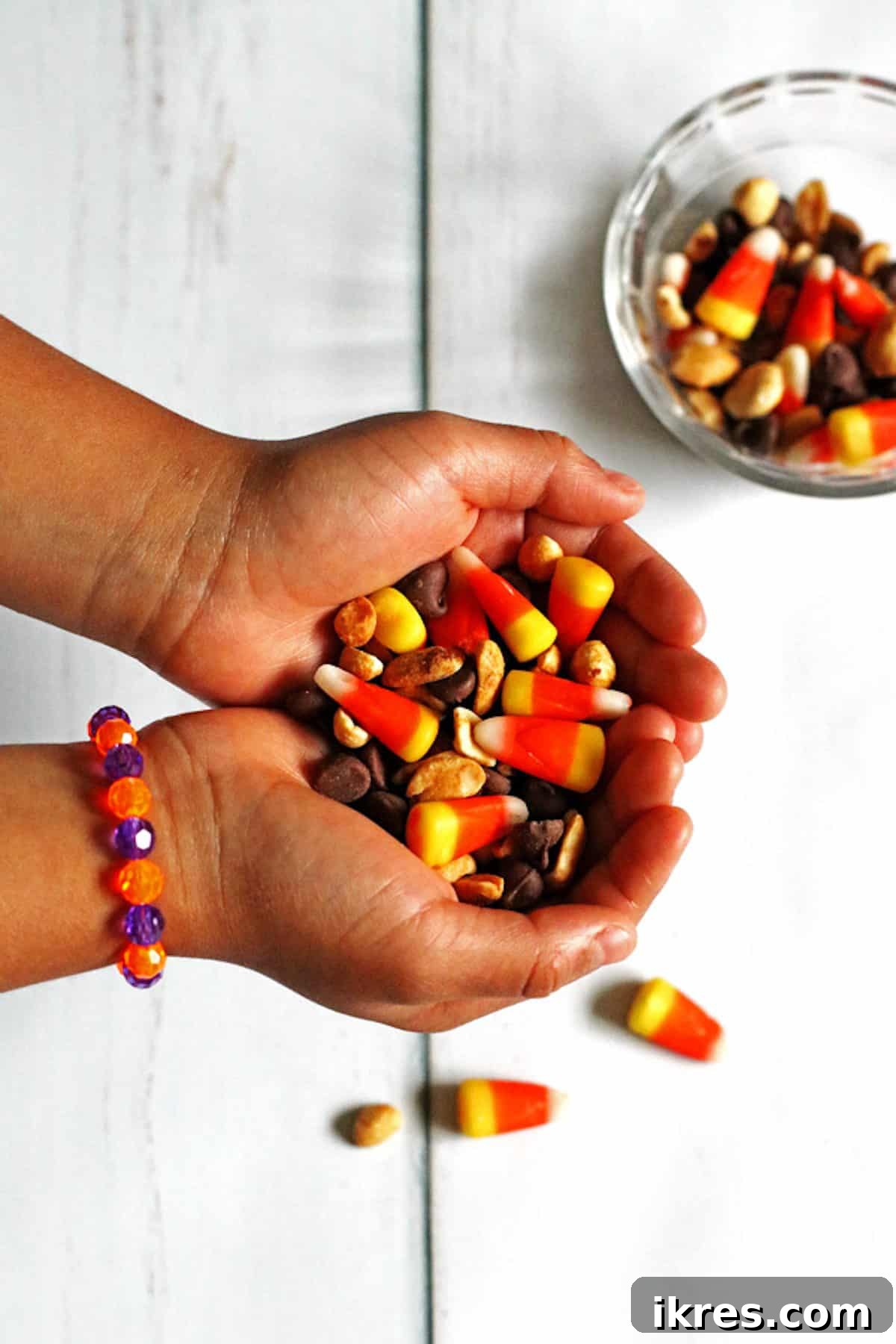 Sweet & Salalty Candy Corn Crunch 6 Candy Corn Snack Mix in a child's hands, showing its appeal to younger audiences.