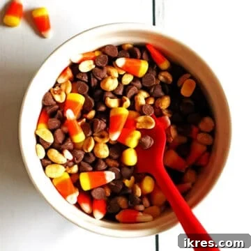Sweet & Salalty Candy Corn Crunch 7 A bowl of candy corn party mix with a red spoon.