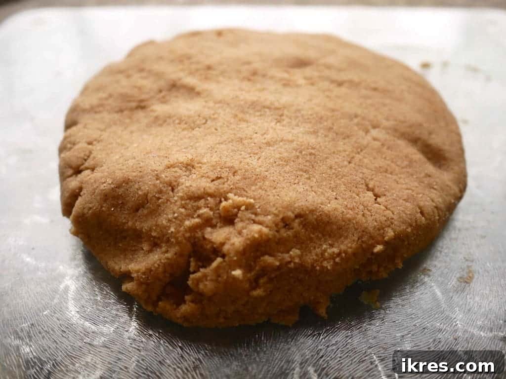 Cinnamon Paleo Scones 5 Paleo scone dough flattened on a cutting board.